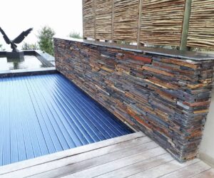 Natural stonework for pool - strip-wall design
