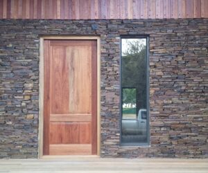 Natural stone exterior wall for home - strip-wall design