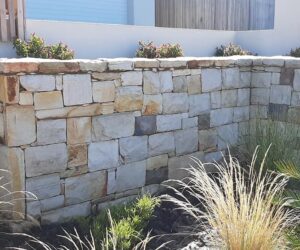 Natural stone retaining walls in garden - square and brick design